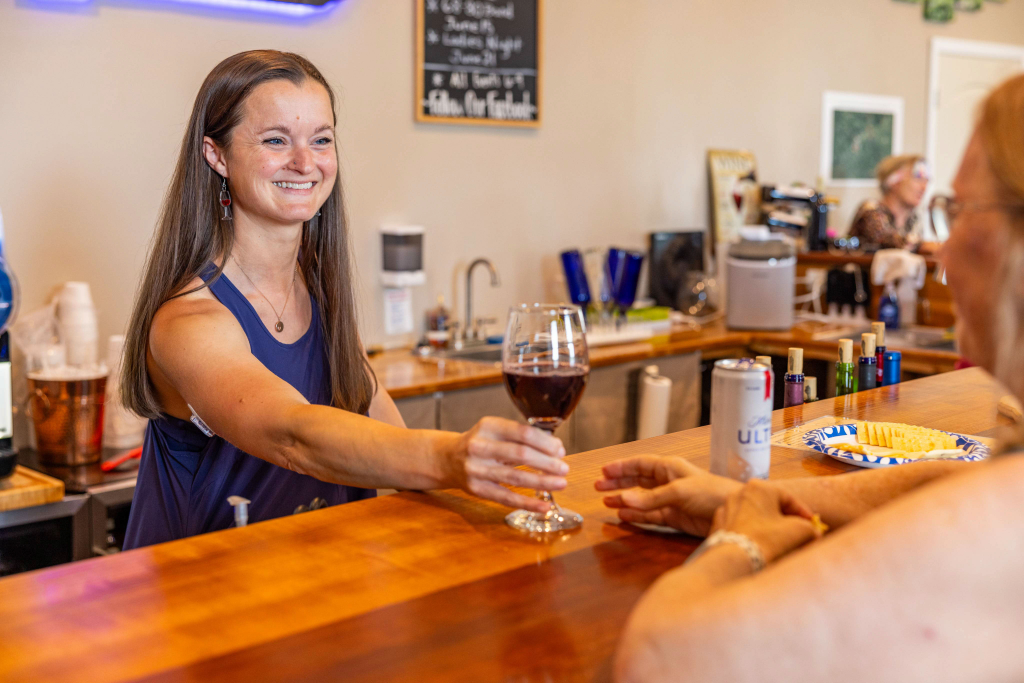Owner Jessica Rogers serving a glass of red wine toa customer at Bluegrass Vineyard in Smiths Grove Kentucky