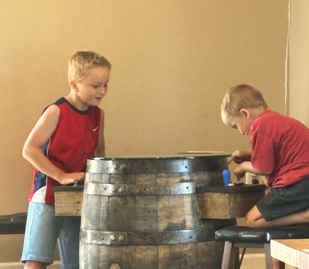 children playing games on a bourbon barrel at Bluegrass Vineyard in Smiths Grove Kentucky